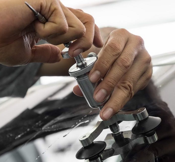Close-up of resin being injected into a windshield chip